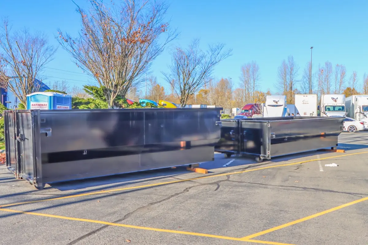 Professional dumpster rental service with roll-off container on residential driveway in New Richmond